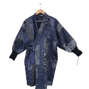 May include: A blue and white patchwork kimono robe with long sleeves and a tie belt. The robe is made of a soft, comfortable fabric and features a traditional Japanese design.