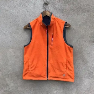 May include: Orange fleece vest with a zipper closure and a black lining. The vest has two zippered pockets on the front.