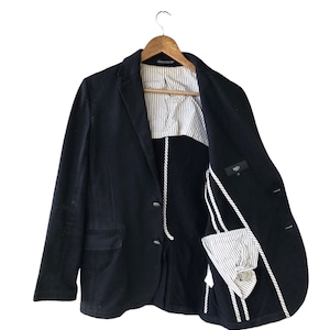 May include: A black blazer with a white and black striped lining. The blazer has a single button closure and two pockets.