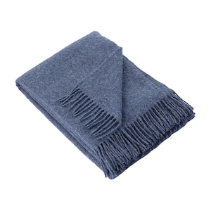 May include: A soft, blue throw blanket with a fringed edge. The blanket is folded in half and has a textured surface.