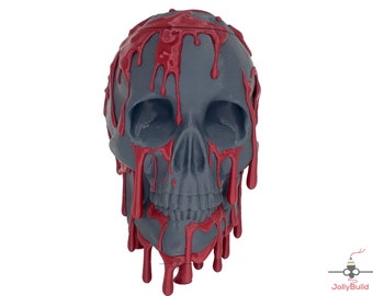 May include: A gray skull with red dripping paint, a Halloween decoration.