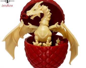May include: A white dragon figurine with open wings inside a red dragon egg. The egg is textured with scales and has a hinged top.