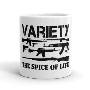 May include: White ceramic mug with a black graphic of various guns and the text "VARIETY THE SPICE OF LIFE".