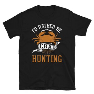 May include: Black t-shirt with a white graphic of a crab and the text "I'd rather be crab hunting".