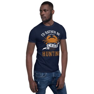 May include: A navy blue t-shirt with a white graphic of a crab and the text "I'd rather be crab hunting".