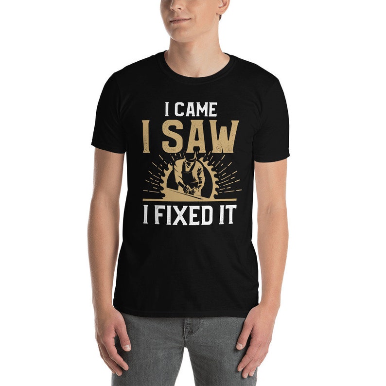 May include: Black t-shirt with a white graphic that says "I came I saw I fixed it" and a cartoon image of a person using a saw.