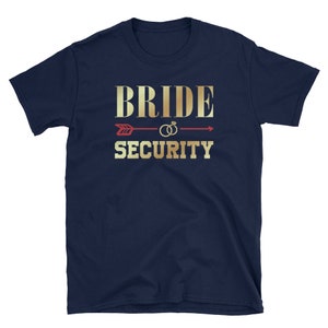 May include: Navy blue t-shirt with gold text that reads "Bride Security" and a red arrow with gold rings.