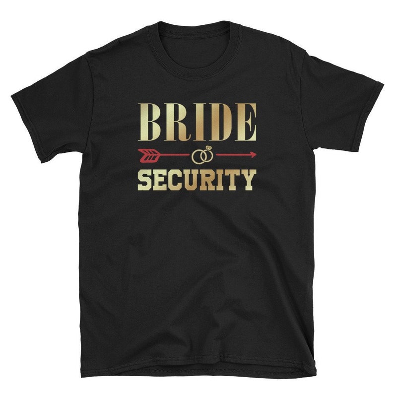 May include: Black t-shirt with gold text that reads "Bride Security" with a red arrow and two gold rings above the text.