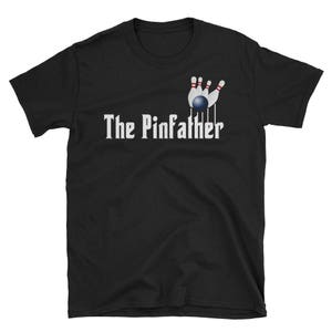 May include: Black t-shirt with a white graphic of a bowling ball and pins. The text "The Pinfather" is printed below the graphic.