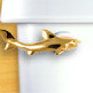 May include: A gold-colored shark pendant charm. The shark is facing right and has a detailed design.