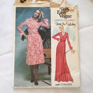 May include: Vintage Very Easy Vogue sewing pattern featuring a wrap dress design by Diane Von Furstenberg. The pattern cover shows a woman in a red and white patterned dress and a red wrap dress. The pattern number is 1549.