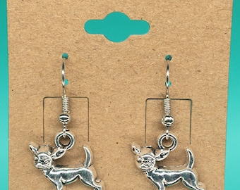 May include: A pair of silver dangle earrings featuring a chihuahua silhouette. The earrings have a silver hook closure.