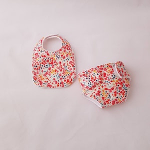 Liberty Phoebe baby diaper, bib and wipes available in several sizes