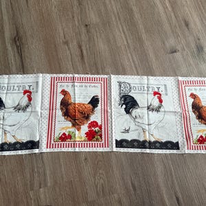 May include: A continuous length of fabric featuring four repeating rectangular panels. Two panels display a white rooster with the text POULTRY, and two panels display a brown rooster with the text For the Farm and the Garden.