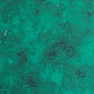 May include: A close-up of a green fabric with a mottled texture. The fabric has a dark green and light green pattern.
