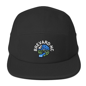 May include: Black 5-panel cap with an embroidered logo of a circle with a landscape scene and the text "Brevard, NC".