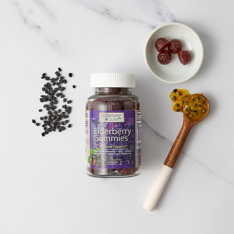 May include: A bottle of Elderberry Queen Elderberry Gummies with a purple label and a white cap. The bottle is filled with purple gummies. The label says "Immune Support" and "60 Gummies".