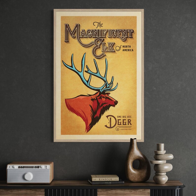 Framed Magnificent Elk poster displayed in an office featuring bold North American wildlife art and retro typography