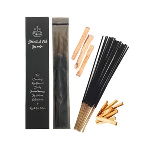 May include: A package of black incense sticks with a black and white label that reads "Essential Oil Incense" and lists uses for cleansing, mindfulness, clarity, aromatherapy, meditation, relaxation, and mood elevation. The package is next to a pile of wooden sticks.