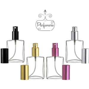 May include: Six clear glass perfume bottles with different colored caps. The caps are black, silver, gold, and pink. The bottles are square shaped and have a spray nozzle. The bottles are arranged in two rows of three. The text "The Parfumerie" is at the top of the image.