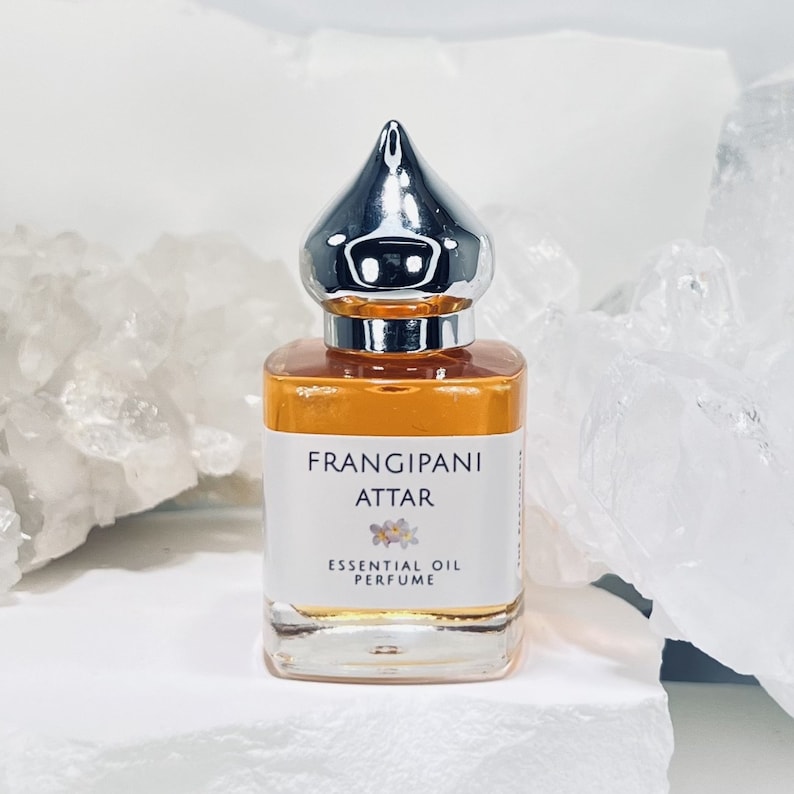 Frangipani Absolute Attar Essential Oil Perfume in a 15 ml Perfume Bottle with a pointed shiny cap.