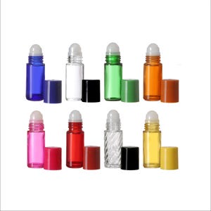May include: Set of eight glass roller bottles with different colored glass and caps. The bottles are clear, blue, green, orange, pink, red, yellow, and a clear bottle with a textured surface. The caps are black, white, and various colors.