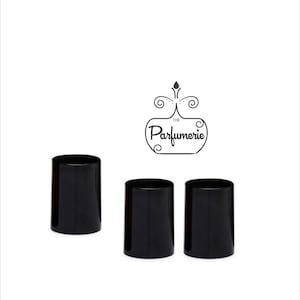 May include: Three cylindrical black containers with a smooth, glossy finish. Above the containers, a black line-art logo features a stylised perfume bottle shape with decorative swirls and the text "The Parfumerie" written in a script font.