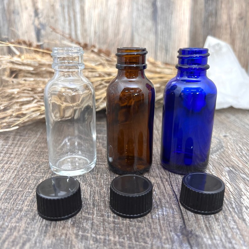 One ounce (1 oz.) (30 ml) amber glass Boston round bottle with black cap for essential oils, attars, Jasmine, Amber White.