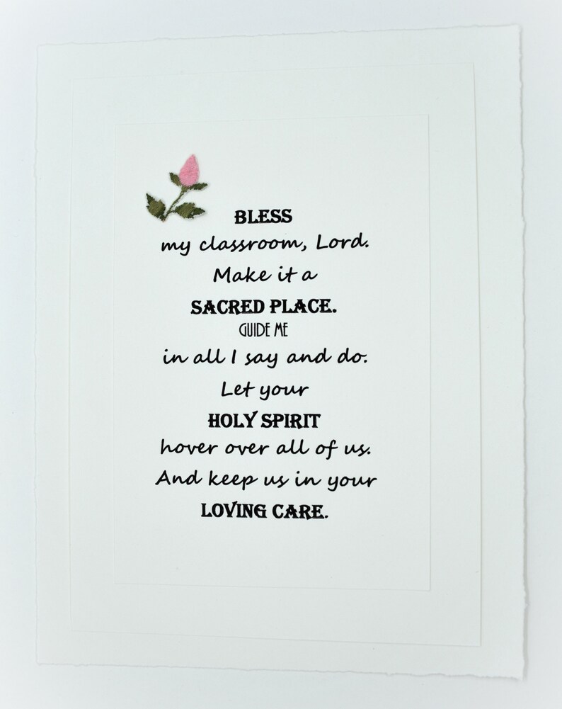 May include: A white card with a pink flower and black text that reads: "BLESS my classroom, Lord. Make it a SACRED PLACE. GUIDE ME in all I say and do. Let your HOLY SPIRIT hover over all of us. And keep us in your LOVING CARE."