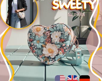 May include: A heart-shaped crossbody bag featuring a floral pattern with light blue, peach, and green tones. The bag has a light blue strap with metal hardware. Text on the image reads: HEARTBAG SWEETY MINI VERSION, PATTERN BY SARAUMARIAM.