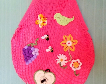 Mesh bag with customized crocheted fruits with bamboo handles.