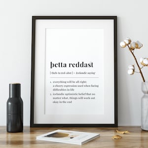 Könnte beinhalten: Schwarz-weißes druckbares Wandbild mit dem isländischen Satz "þetta reddast", was "alles wird gut" bedeutet. Die Definition des Satzes ist darunter in schwarzer Schrift geschrieben.