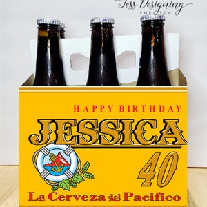 May include: A yellow and white six-pack beer carrier with a birthday message. The carrier has a yellow background with white stripes and the text 