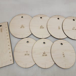 May include: A set of wooden dressmaking templates and a ruler. The templates are circular with size markings like "XXL 26 1/2" and "M 22". The ruler is 12 inches long and marked with inches.