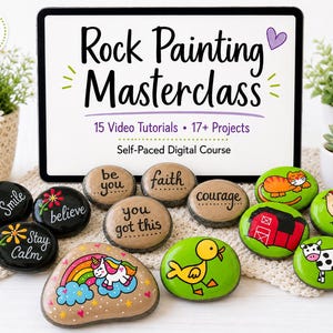 May include: A digital tablet displays the text Rock Painting Masterclass, 15 Video Tutorials, 17+ Projects, and Self-Paced Digital Course. In front are various painted rocks featuring words like smile, believe, be you, faith, courage, you got this, and illustrations of a unicorn, cat, barn, duck, and cow.