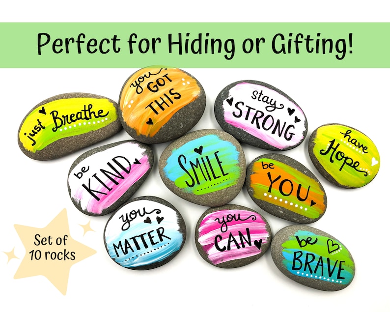 May include: Set of ten painted rocks with positive messages, including "just breathe", "you got this", "stay strong", "be kind", "smile", "be you", "you matter", "you can", "have hope", and "be brave".
