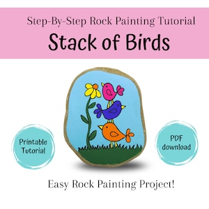 May include: A step-by-step rock painting tutorial for a stack of birds. The rock is painted blue with a green stem and yellow flower. Three birds are stacked on top of each other, painted in orange, blue, and pink. The text "Printable Tutorial" and "PDF download" are in circles on either side of the rock.