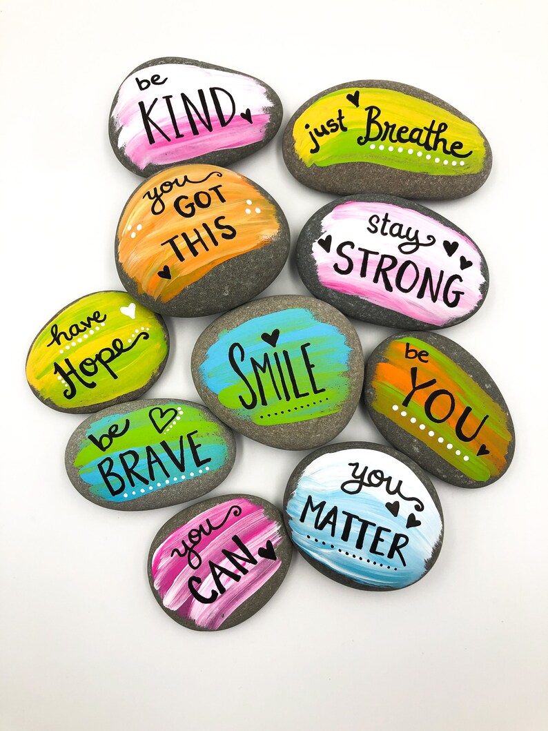 May include: Ten painted rocks with inspirational messages, including "be kind", "you got this", "stay strong", "be brave", "you can", "you matter", "have hope", "just breathe", "be you", and "smile".