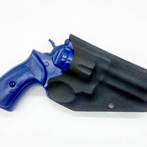 May include: A blue revolver handgun with a black leather holster. The gun has a black barrel and a blue grip. The holster has a single snap closure.