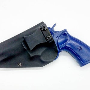 May include: A black leather holster with a clip for carrying a blue revolver.