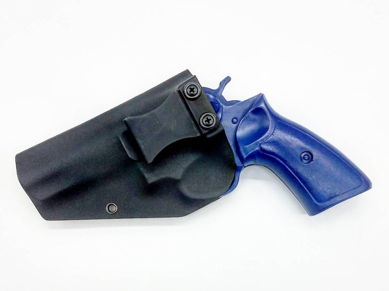 May include: A black leather holster with a clip for carrying a blue revolver.