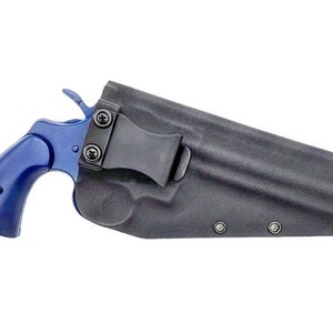 May include: A blue revolver handgun in a black leather holster with a belt clip.