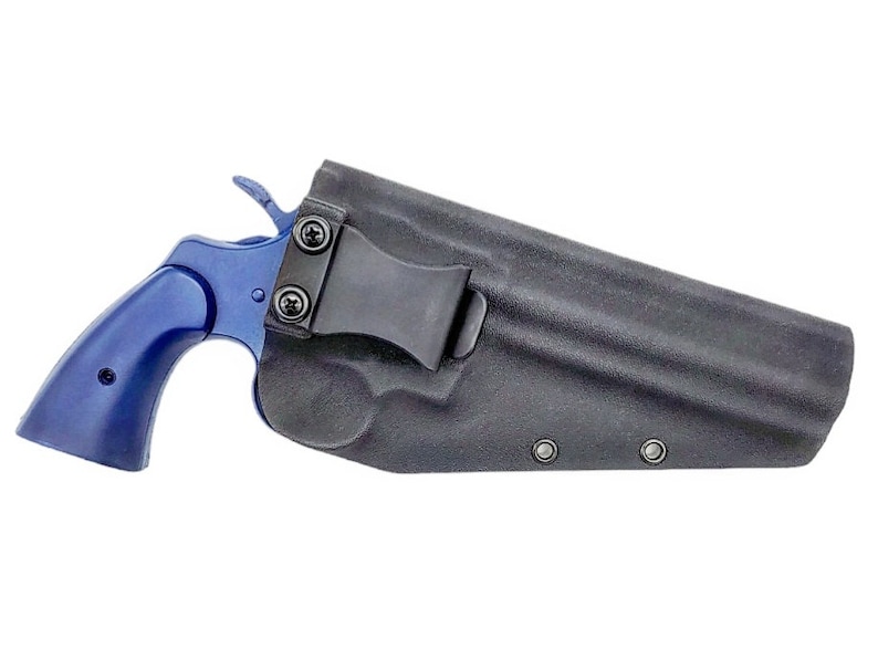 May include: A blue revolver handgun in a black leather holster with a belt clip.