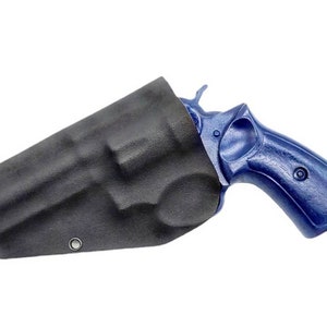 May include: A black leather holster with a blue revolver inside. The holster has a single metal eyelet.