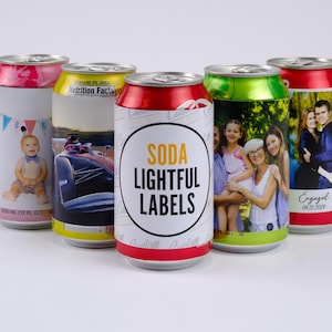May include: Five aluminum soda cans with personalized labels. The labels feature different photos and text, including a birthday party, a race car, a family portrait, and an engagement announcement. The text on one can reads "Soda Lightful Labels".