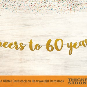 May include: Gold glitter banner with the text "cheers to 60 years". The banner is made of non-shed glitter cardstock on heavyweight cardstock. The banner is thicker and stronger.