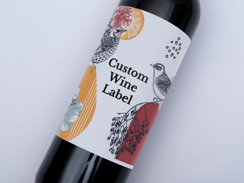 May include: A white wine bottle label with a custom design. The label features a floral pattern, two birds, and the text "Custom Wine Label".