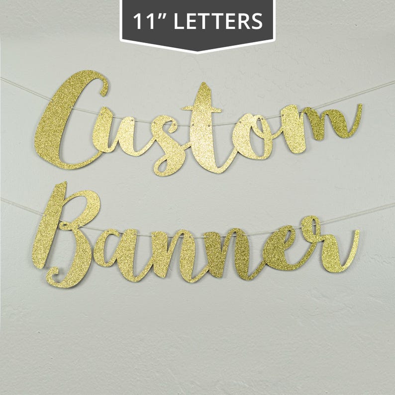 May include: Gold glitter custom banner with the words "Custom Banner" in 11 inch letters.