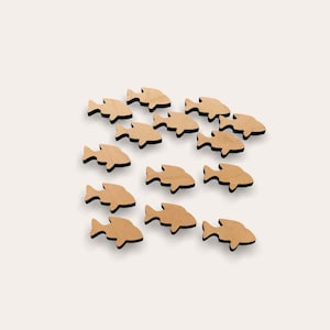 May include: A school of wooden fish cutouts in various sizes, arranged in a line formation, on a white background.