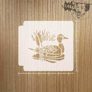 May include: A stencil featuring a duck swimming in water with cattails in the background. The duck is detailed with a curved neck and a defined beak. The stencil is made of a light-colored material and is set against a wooden background.